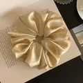 Elegant champagne satin oversized scrunchie hair accessory on a book background - L / Yellow