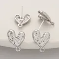 Macro view showing the textured detail of silver-colored heart stud earring components. - Convex Heart / 1 Pair (12x16mm) / Silver
