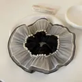 Detailed view of large grey organza hair scrunchie featuring elegant faux pearl accents - Oversized Skirt Style / Gray