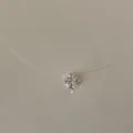 Close-up of minimalist invisible fishing line necklace with a sparkling solitaire pendant - Small Zirconia Necklace