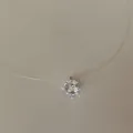 Close-up of a sparkling round cubic zirconia pendant on an invisible fishing line - Large Zirconia Necklace