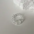 Close-up of translucent heart-shaped stone beaded elastic ring on white background - White