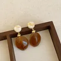 Macro view showing the glossy texture of these brown marbled resin drop earrings - Style 13 (925 Silver Post)