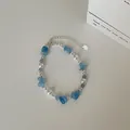 Detail van de kralenketting met natuurlijke aquamarijnsteen en parels op witte achtergrond - Armband