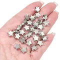 Macro shot of shiny silver star-shaped CCB beads for DIY jewelry making on human hand - Star (BSE045) / 20 Pieces Pack (10mm) / Silver