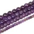 Detailed close-up of natural purple amethyst round beads for jewelry making DIY - 4mm (Approx 93 beads/strand)