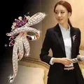 Detailed macro view of elegant purple crystal bow brooch worn on a professional black blazer - Purple Leaf (A6-49)