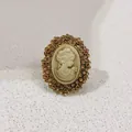 Macro view of vintage cameo brooch with detailed portrait and amber crystals - Multi-Row Pave Rhinestone Border / Vintage Gold Cameo Style (A12-106)