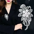 Detailed close-up of a silver flower brooch with pearls and crystals on a black blazer - Artificial Pearl Flower (A6-66)
