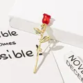 Close-up detail of an elegant red rose brooch pin featuring a golden stem and leaves - Blooming Rose Style (A8-31) / Red