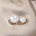 Double white pearl brooch pin for waist adjustment on champagne silk background - L / White