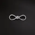 Macro shot of an elegant silver bow brooch embellished with sparkling rhinestones - Bowknot Pave Rhinestone Flower Style (A3-79)