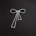 Detailed macro view of a sparkling silver-tone rhinestone bow brooch with hanging tassels - Bowknot Tassel Chain Style (A3-80)