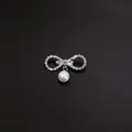 Detailed view of an elegant silver bow brooch with sparkling rhinestones and a hanging pearl. - Bowknot Single Artificial Pearl Style (A3-82)