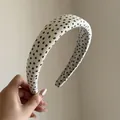 Close-up view of a white fabric padded headband featuring a delicate black floral print - White Floral Wide Headband