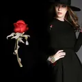 Detailed view of an elegant red rose brooch with crystals and teardrop pendant - A3-84