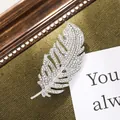Close-up detail of an elegant silver feather brooch encrusted with shimmering rhinestones - Feather Style (A18-19)