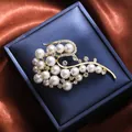 Close-up of elegant gold-plated brooch with white pearls and sparkling crystals - Streamlined Flower Cluster Style (A16-118) / Gold