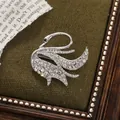 Macro view of an elegant silver alloy swan brooch with sparkling rhinestone inlay details - Single Swan Style (A15-103) / Silver