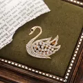 Detailed view of an elegant golden alloy swan brooch with clear rhinestones. - Single Swan Style (A15-110)