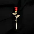 Elegant vintage red rose brooch pin with golden stem displayed on black textured fabric - A8-31