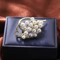 Detailed view of elegant gold floral pearl brooch with sparkling rhinestone leaf design - Elegant Leafy Flower (A16-104)