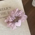Detailed close-up of pink floral scrunchie hair tie with soft fabric heart detail - Pink Floral Scrunchie With Heart