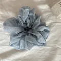 Close-up detail of a light blue floral print scrunchie resting on white fabric - 8#
