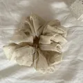 Close-up of a yellow floral scrunchie hair accessory on a white fabric background - 9#