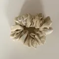 Detail view of a yellow floral scrunchie with soft fabric texture and pleated design. - 11#