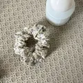 Elegant floral pattern scrunchie hair tie featuring a cream base with purple flowers - Yellow And Blue Floral Scrunchie