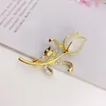 Detail shot of elegant tulip brooch with white cat-eye stone and crystal accents - Luxury High-end Style (A10-115)