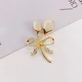 Elegant gold-plated tulip brooch with cat eye stones and sparkling rhinestone bow detail. - Gold Bow Style (A10-109)