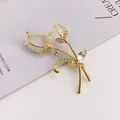 Elegant gold tulip brooch pin featuring white cat's eye stone and shimmering rhinestones. - Fashion Temperament Style (A10-116)