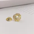 Eleganter vergoldeter Knotenanstecker mit funkelndem Zirkonia für modische Akzente - Gold Knot Stil