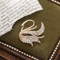 Elegant golden swan brooch inlaid with sparkling crystals presented on green velvet - Single Swan Style (A15-102)