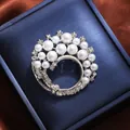 Elegant silver flower brooch with white pearls and sparkling crystals on a blue jewelry box. - Silver Semi-circle Flower Style (A16-115)