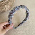 Detailed view of a light blue leopard print mesh headband with inner anti-slip teeth - Non-Slip Toothed Headband / Blue Leopard