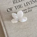 Close-up of a white flower acetate hair claw clip featuring a sparkling center rhinestone. - Small Flower Style (11#)