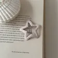Detailed macro view of a star-shaped pink fabric-wrapped BB hair clip on a vintage book page - Star Shape (11#)