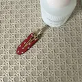 Sweet red hair clip featuring white bow patterns and a delicate gold bow charm detail - Bow Print Gold Bow Accent Style / Red