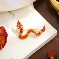 Macro view of a stylized golden dragon brooch featuring orange enamel and sparkling crystal accents - Orange Red Dragon Style (A20-23)