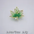 Detailed view of an elegant green maple leaf brooch with rhinestone accent and gold-plated trim - Green White Gradient Maple Leaf (A21-95)