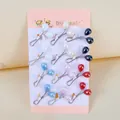 Detail of twelve colorful U-shaped scarf buckles featuring elegant faux pearl bead ends - Waterdrop Artificial Pearl Style