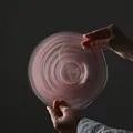 Artistic round glass fruit plate featuring a pink swirl pattern and frosted texture - Flat Ink Wash / Pink