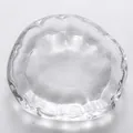 Macro view of clear Japanese style glass tea cup with hammered texture and wavy rim - Transparent Coaster