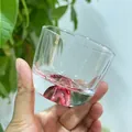 Elegant Japanese glass cup featuring a pink Mount Fuji base design for tea and sake - Foundation