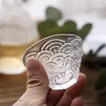 Handheld Japanese clear glass sake cup with wave pattern for elegant wine drinking - Wave Pattern Sake Cup
