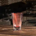 Elegant pink octagonal heat-resistant glass tea smelling cup on a rustic wooden table - Transparent Red