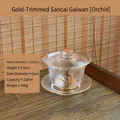 Eleganter Gaiwan-Teeschale aus Kristallglas mit Goldrand und Orchideen-Motiv - Gaiwan mit Orchideenmuster / Orchidee + Goldrand-Untersatz